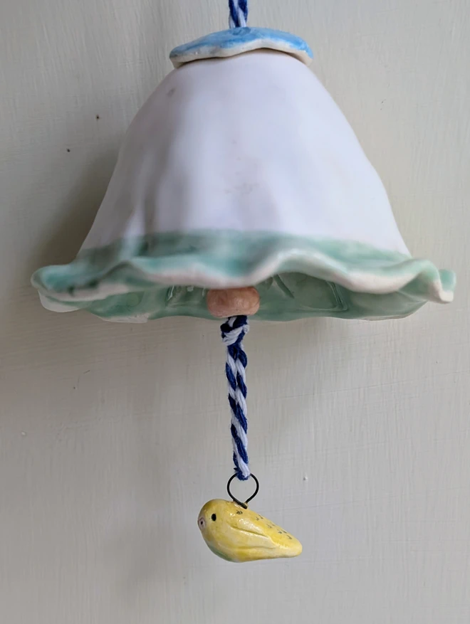 pottery budgie hanging bell decoration with a miniature yellow ceramic bird