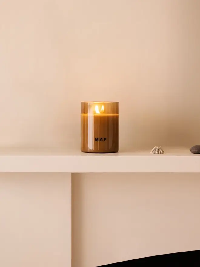 road to marrakesh rose and petitgrain soy candle. candle placed on mantelpiece.