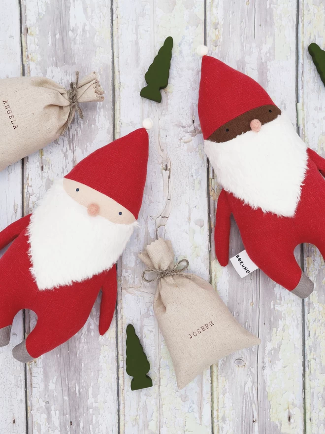 santa clause dolls with light and dark skin and personalised sacks