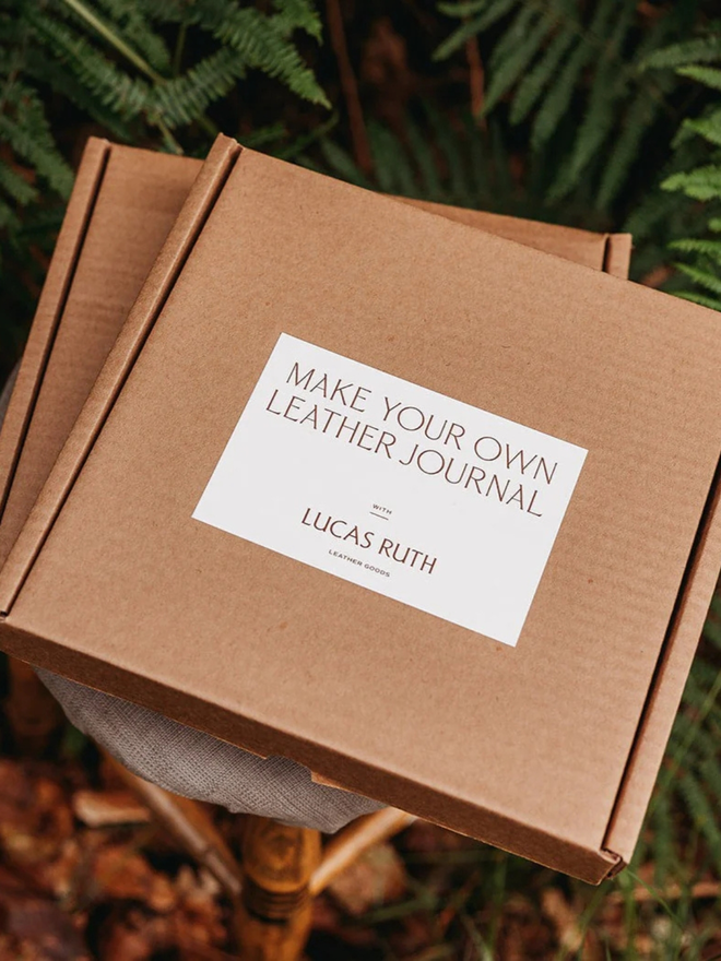 make your own leather journal. a cardboard box with lucas ruth logo on front to show product packaging. 