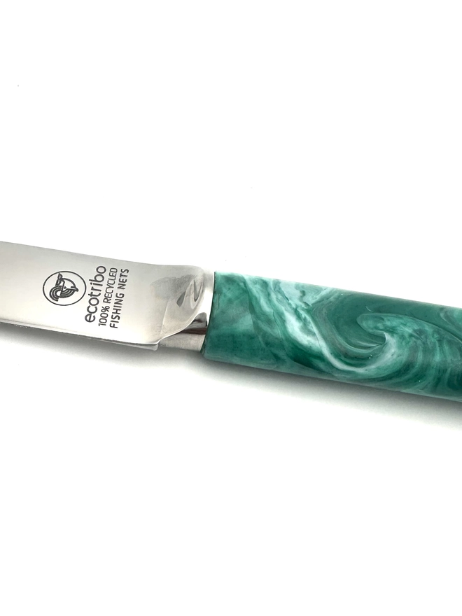 Eco-friendly cheese knife created from reclaimed ghost nets collected from UK coastlines and transformed into a durable kitchen tool.