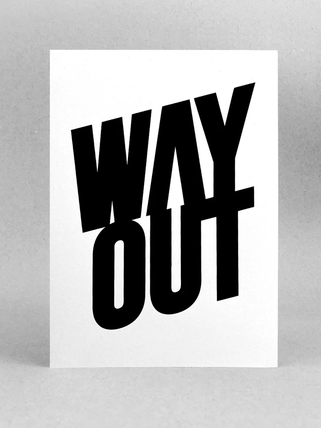WAY OUT screenprinted in black, with an arrow pointing the way, embedding in the negative space of the lettering. Sat in a plain light grey background, with soft shadows.
