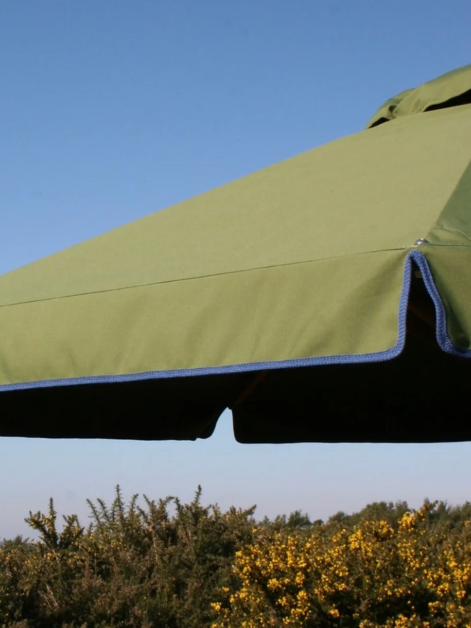 Parasol with Contrast Colour Trim. A parasol in olive green with blue trim