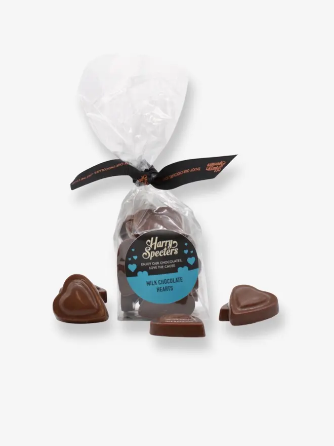 A bag of luxury milk chocolate hearts tied together with a ribbon