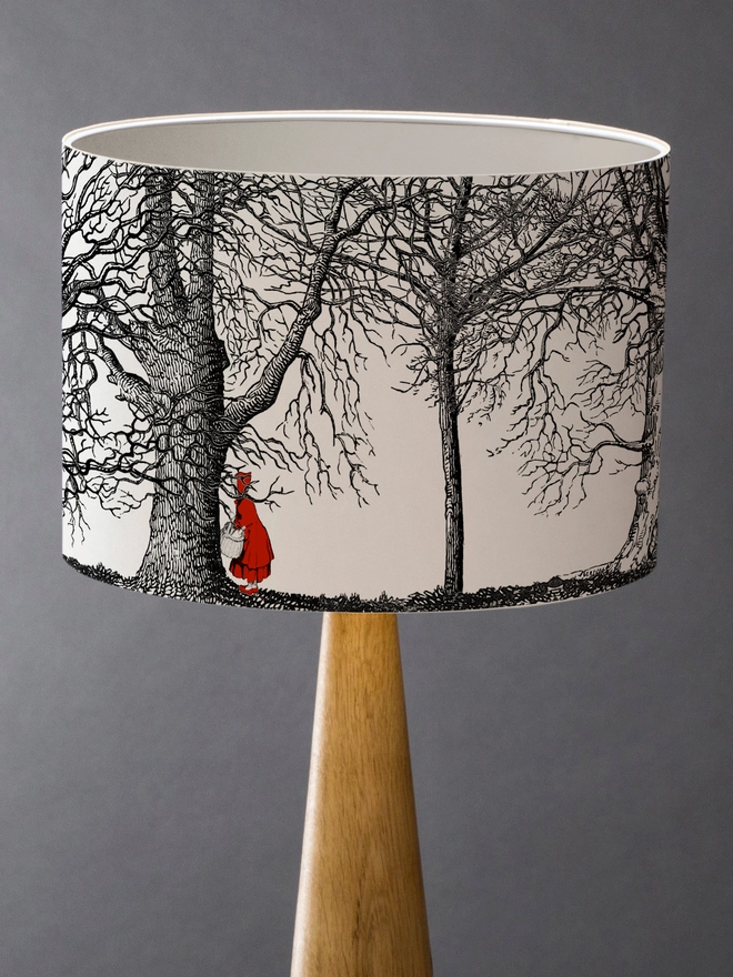 Handmade drum lampshade featuring a whimsical Little Red Riding Hood inspired design with a red cape, big bad wolf, and dark woodland scene.