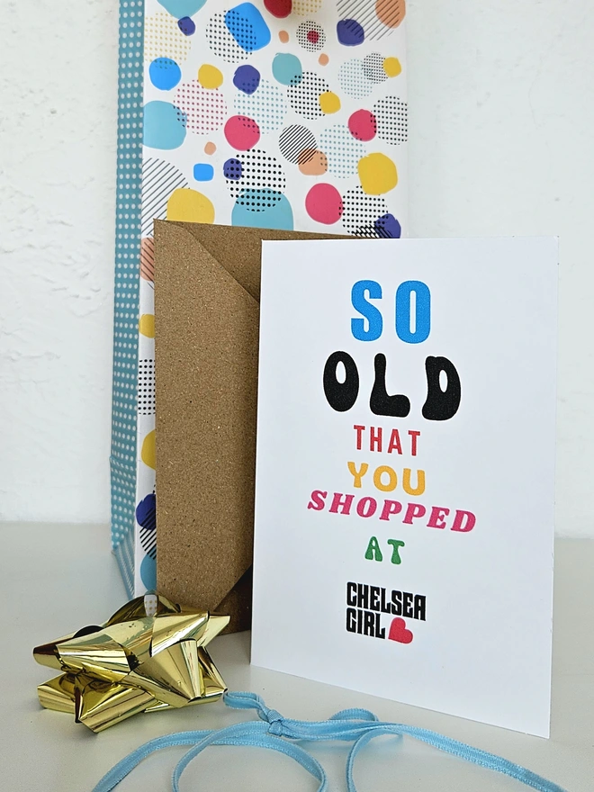 A photograph of the front of a humorous A6 greeting card illustrated using brightly coloured text and the retro shop logo. The text says so old you shopped at Chelsea Girl
