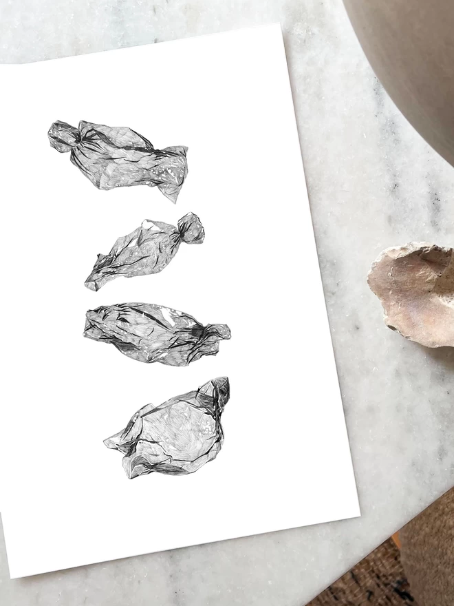 Art print of hand drawn illustrations of empty sweet wrappers laying on a table