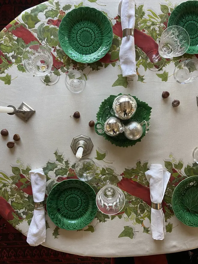 christmas double garland tablecloth. a white table cloth with two painted christmas garlands on a table.