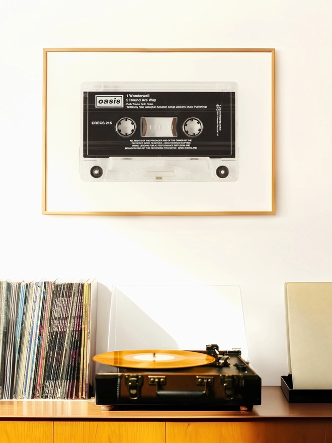 oasis wonderwall cassette tape print. framed print hung up above record player and vinyl collection.