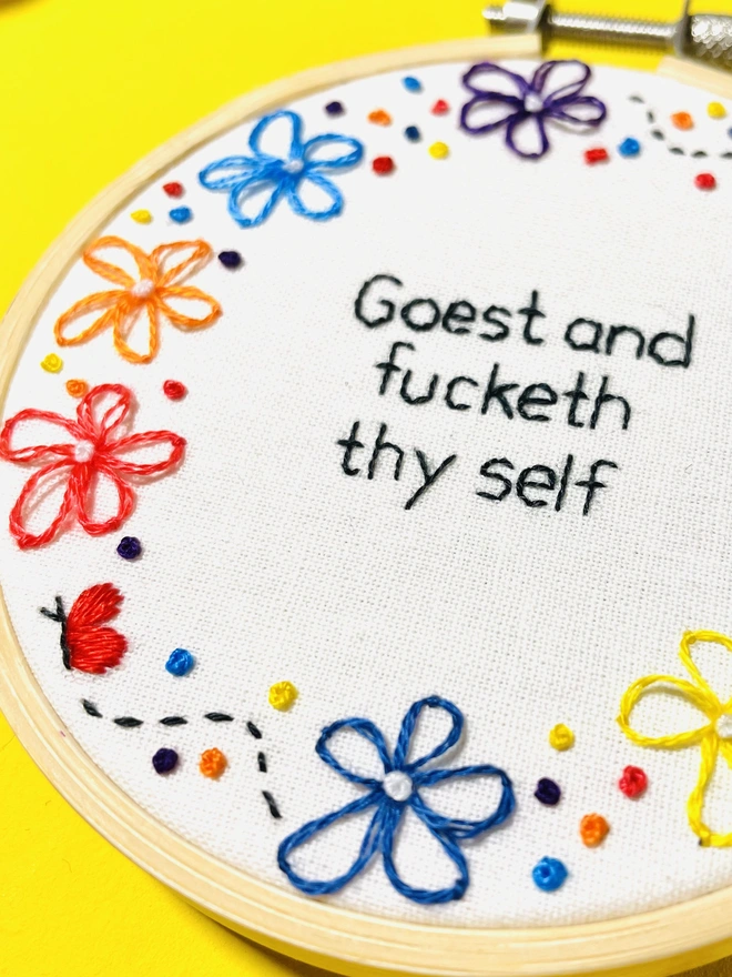 Close up of a hand embroidery funny wall hanging quote