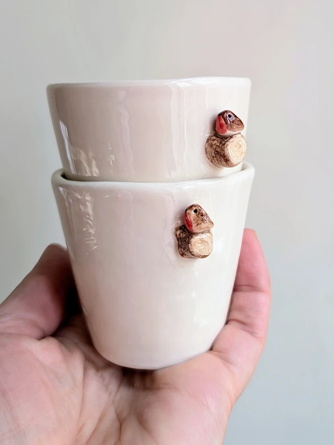 white ceramic espresso coffee cups with tiny robin red breast bird on a ceramic tree branch