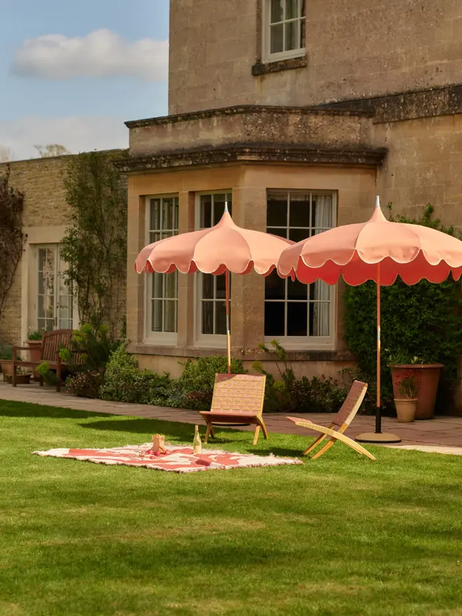 coral pagoda parasols in green garden