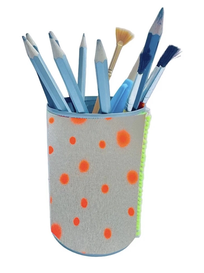 Upcycled & Repurposed Linen Tin Holder Polka Dot Print, a colourful polka dot tin on a white surface with pens and brushes in it. 
