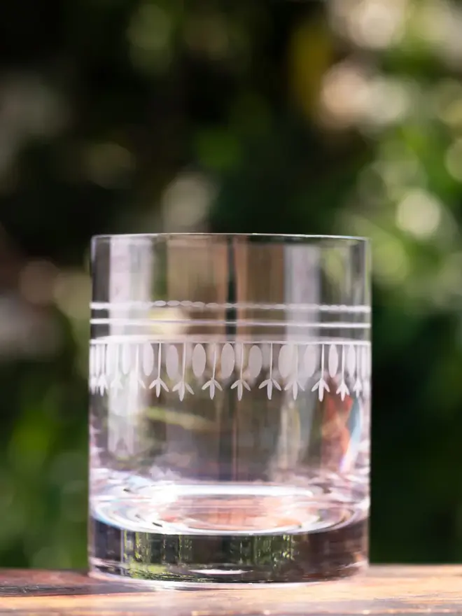 engraved ovals crystal whisky glasses. a drinks glass engraved with a detailed oval pattern.