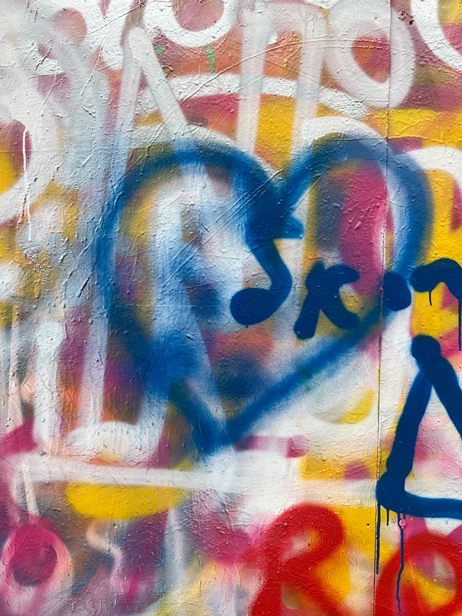 A London spray paint blue love heart, set against the graffiti wall background and the the source of inspiration for this artwork.