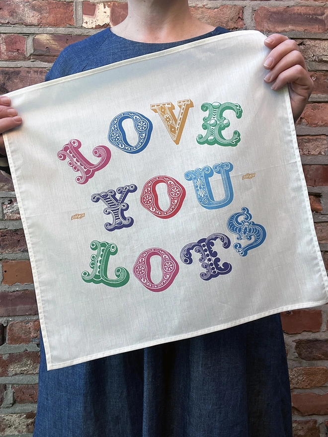 A Mr.PS Love You Lots Multicolour handkerchief held in front of a woman