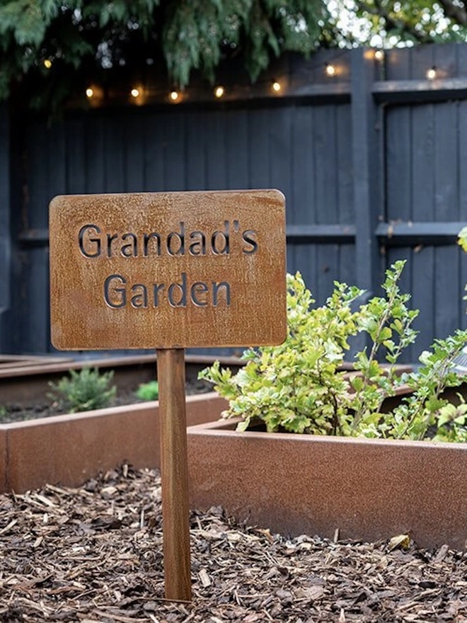 Personalised Garden Sign, in ground with stake saying: 'Grandad's Garden'.
