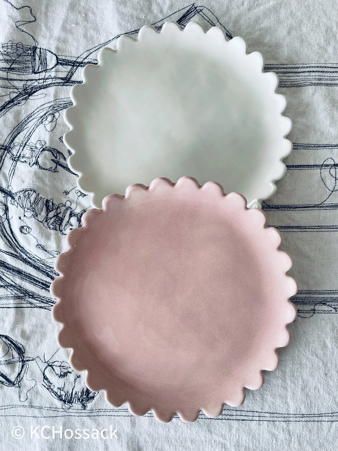 pink and white side dessert plates on a white tablecloth