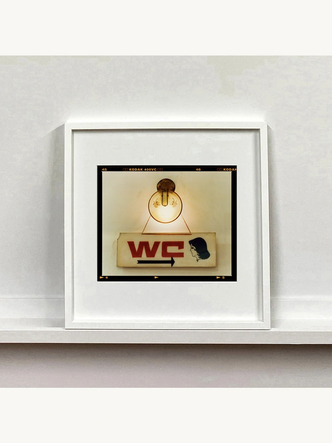 WC sign photograph mounted square framed in white