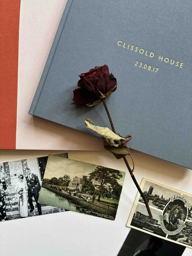 two stacked handmade photograph albums by Keep Collect with gold foiled personalisation and photo ephemera