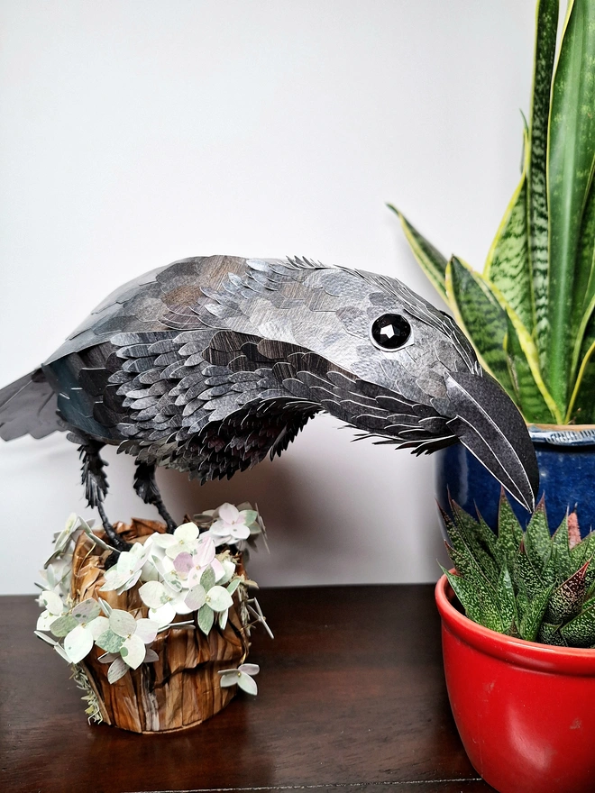 Handmade paper sculpture depicting a raven