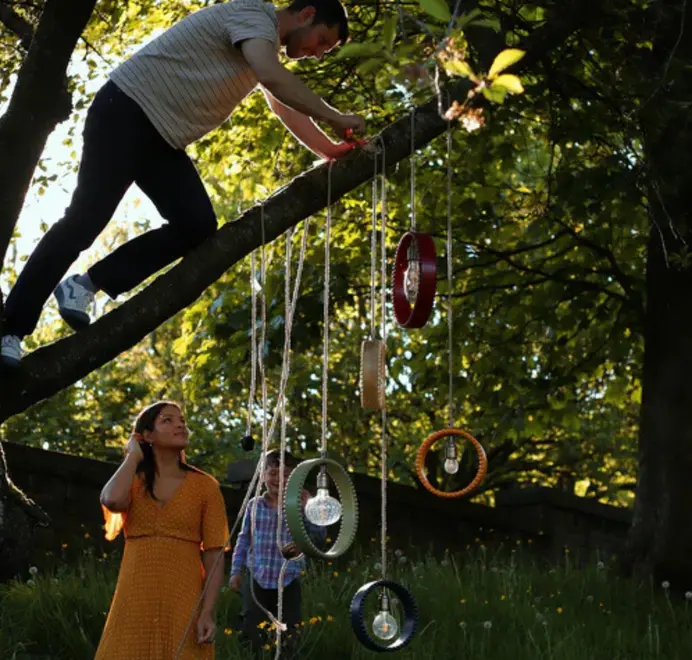 ring shaped pendant lights hanging from a tree