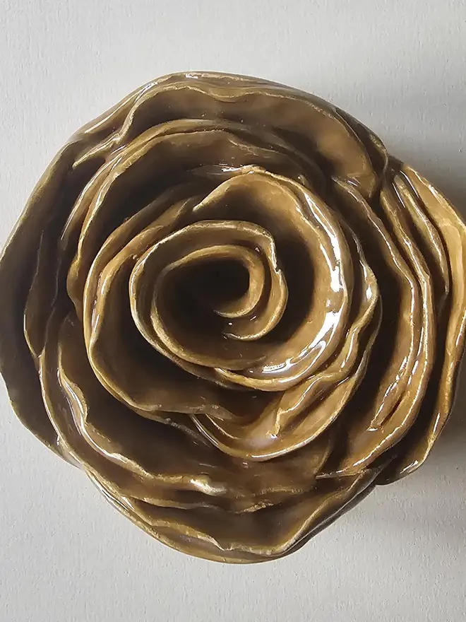 caramel tan camel brown handmade ceramic rose sculpture with a glossy glaze, crafted in 3D and designed to hang on a wall