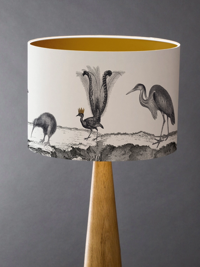 Drum Lampshade featuring birds with a gold inner on a wooden base 