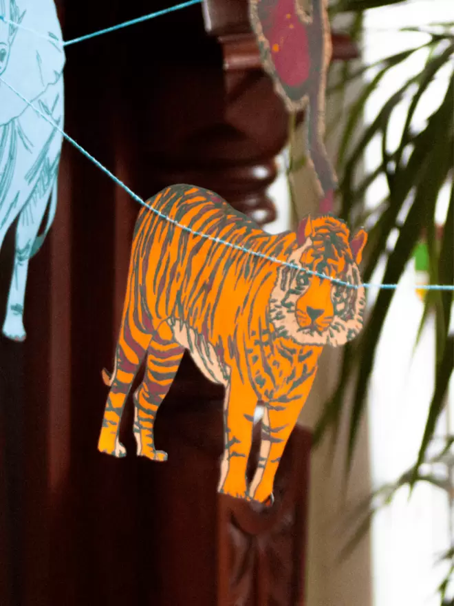 Bright orange striped tiger hanging in front of wooden fireplace