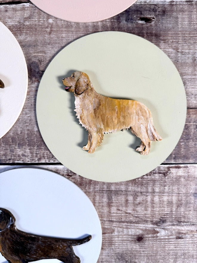 Hand Painted Golden Retriever Portrait mounted onto a circular wooden background also handpainted in pale pink 