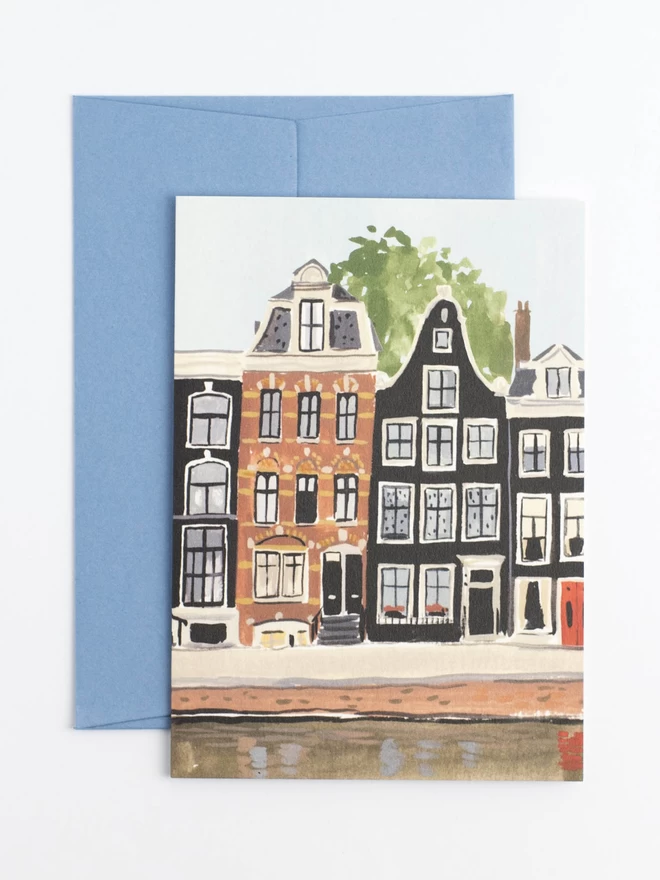 An illustrated scene of amsterdam, featuring a row of black and brown houses by a canal.