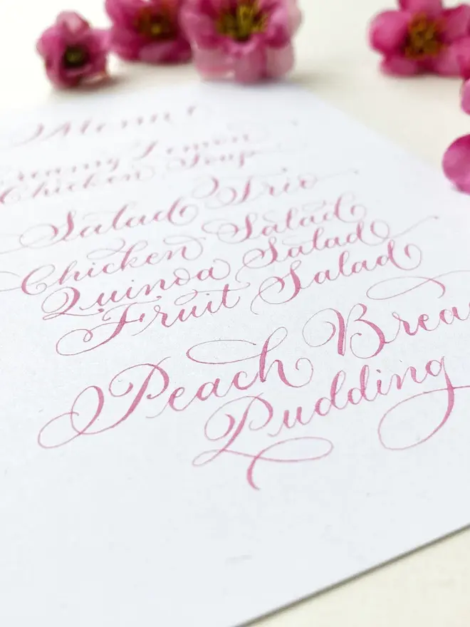 calligraphy wedding menus. white menu with pink calligraphy.