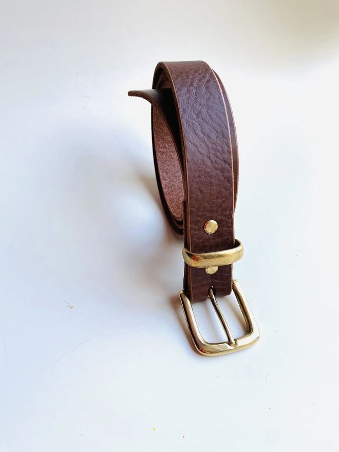 Brown leather belt with brass buckle