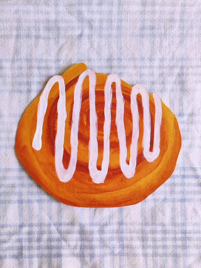 hand painted cinnamon roll cut out on gingham cloth