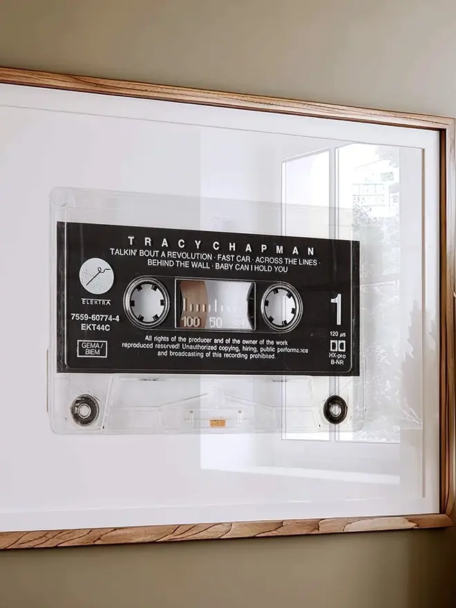 tracy chapman fast car cassette tape print. framed print hung on wall.