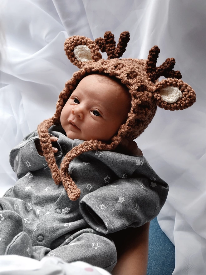 Baby wearing deer bonnet