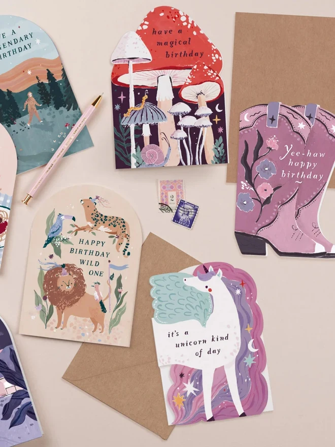 Unicorn Birthday Card in a flat lay of illustrated birthday cards and kraft envelopes
