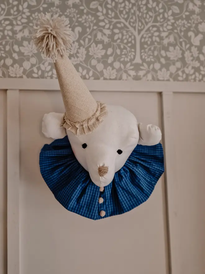 Bear Head Nursery Decoration, a bear decoration sitting against a wall in a child's decorated bedroom. 