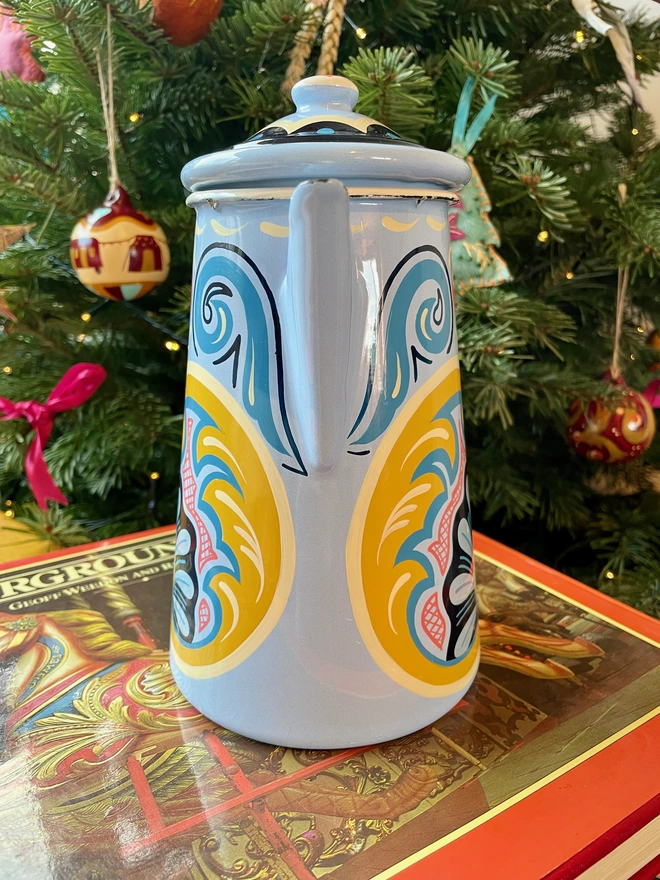 Blue enamel coffee pot hand painted with a fairground design in blue, pink and yellow