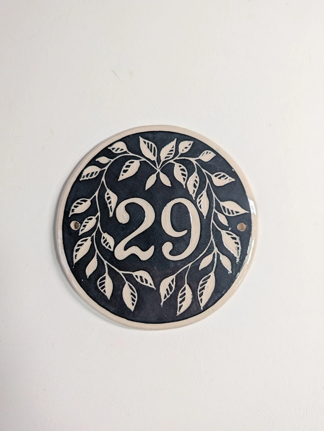 Small round house number with Leaf decoration in BLACK