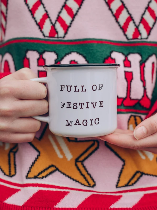 child holding christmas mug with text 'full of festive magic'