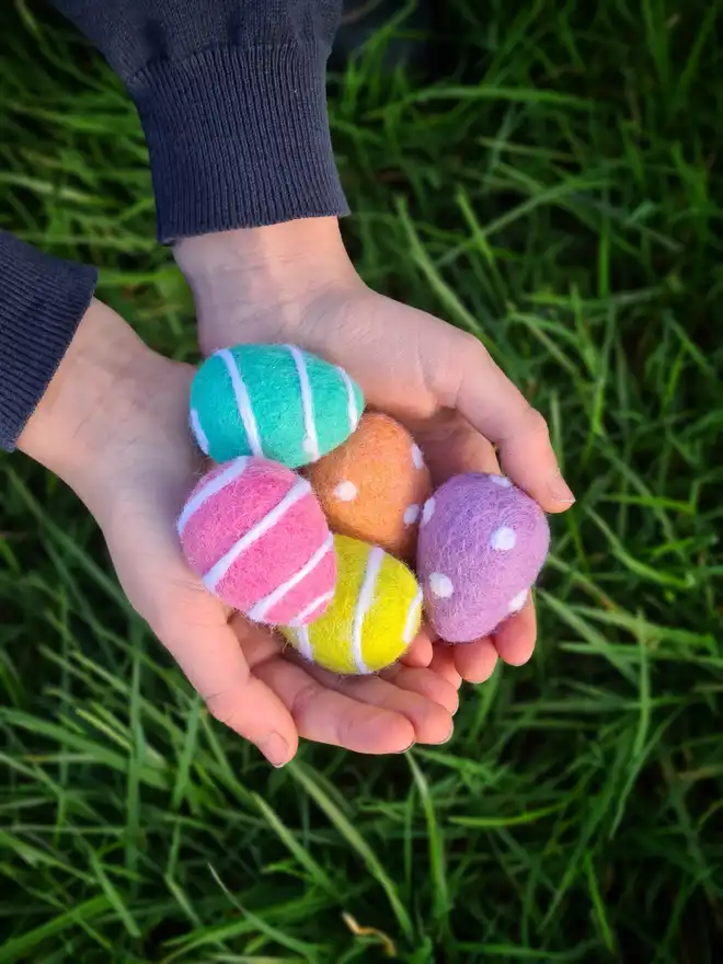 loose felt eggs in a childs hand
