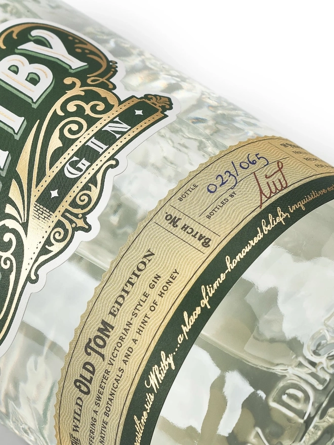 Wild Old Tom Edition Gin, a bottle of gin sitting on a plain white surface. 