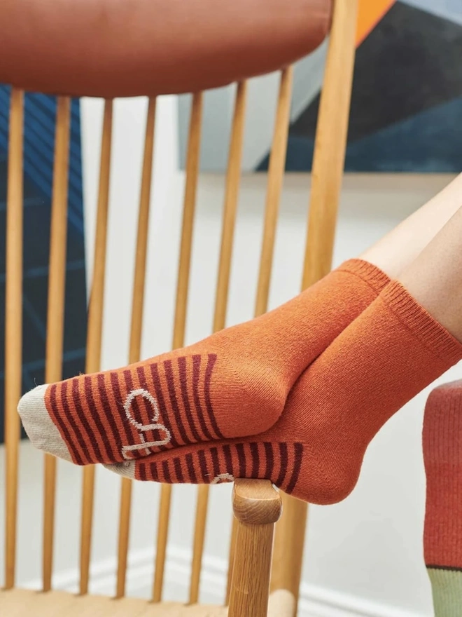 Women's Organic Cotten Striped Arch Ankle Socks, a woman wearing a pair of colourful arch ankle socks. 