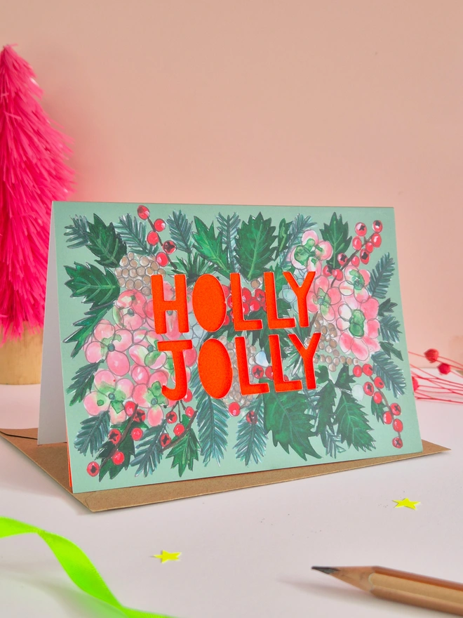 Holly and Hydrangea Christmas Card with Holly Jolly slogan and neon red paper behind it
