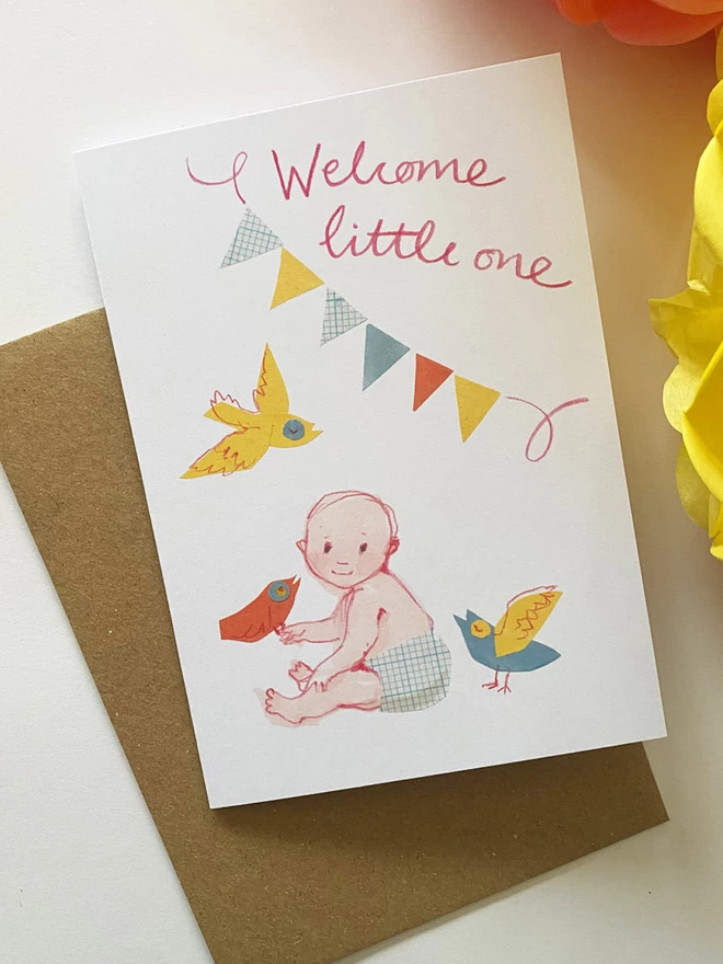 Yellow, pink and blue illustrated greetings card by Esther Kent, showing a little baby holding a bid, under bunting and handwriting that reads 'Welcome little one'.