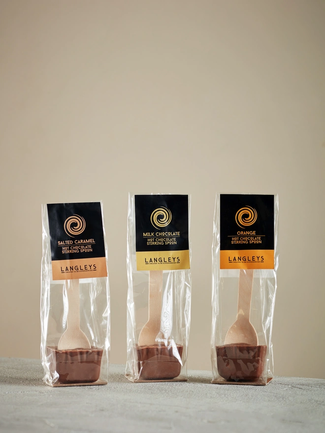 Hot Chocolate Stirring Spoon Collection (Set Of 3), a group of chocolate serving spoons sitting on a plain surface.