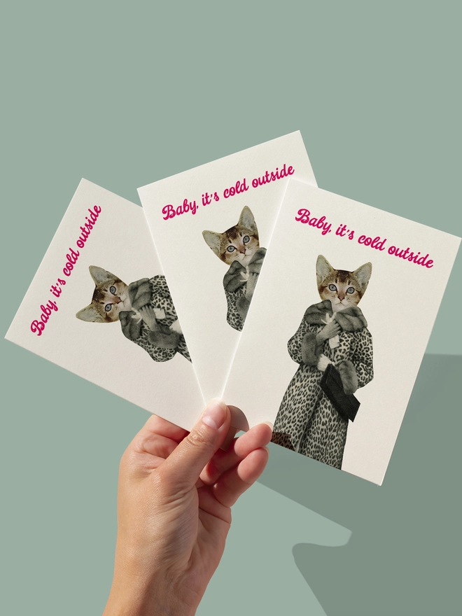 A funny Christmas card featuring a cat wearing a leopard print coat.
