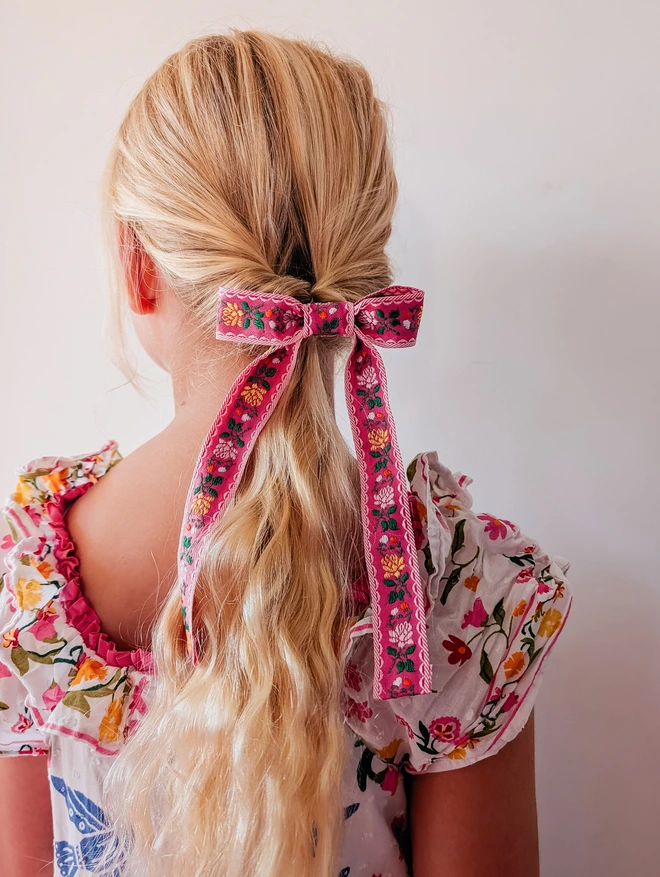 Girl with blonde hair wearing her hair bow