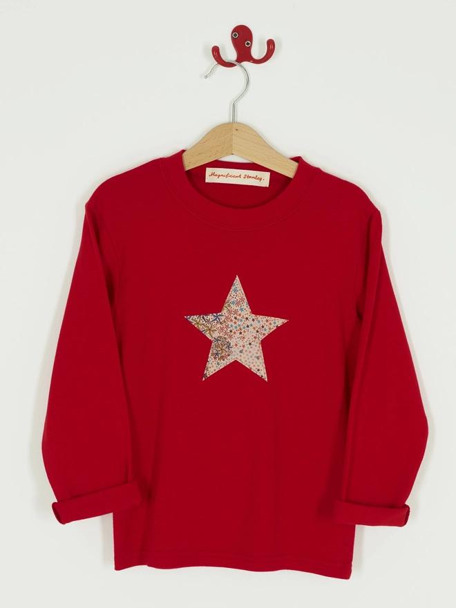 a red tee with a christmas star cut from starry liberty print sewn onto the front